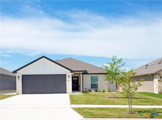 1423 Fiddle Wood Way, Temple, TX 76502 - view of front facade featuring stone siding, a garage, concrete driveway, a front yard, and board and batten siding