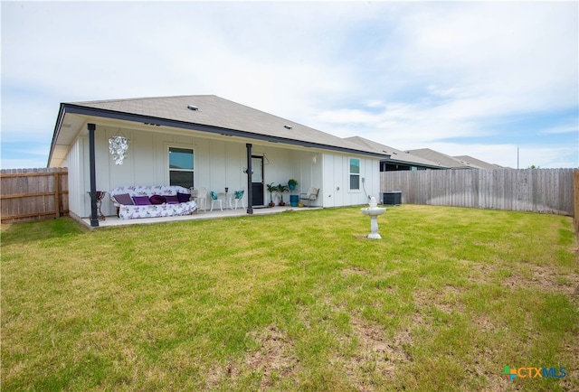 back of house featuring central AC, a yard, and a patio area