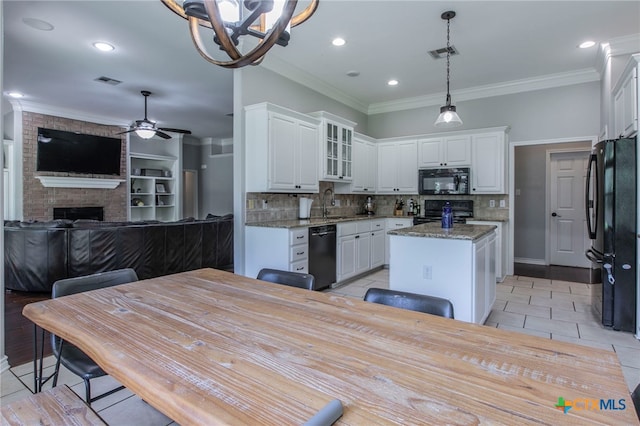11503 Meredith Dr, Belton, TX 76513 - kitchen with black appliances, a center island, a chandelier, white cabinetry, and open floor plan