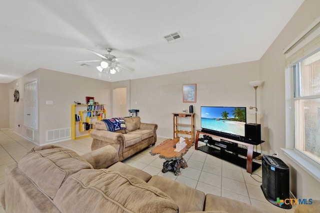 living area with light tile patterned floors, ceiling fan, plenty of natural light, and visible vents