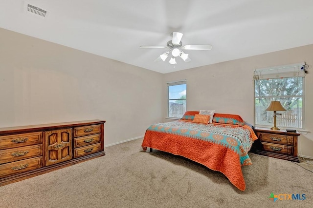 bedroom with carpet floors, baseboards, visible vents, and ceiling fan