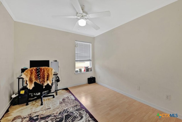 office space featuring baseboards, ornamental molding, and light wood-type flooring