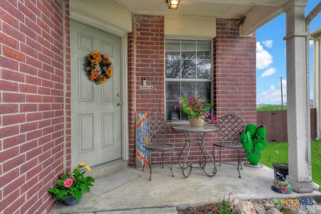 entrance to property featuring brick siding