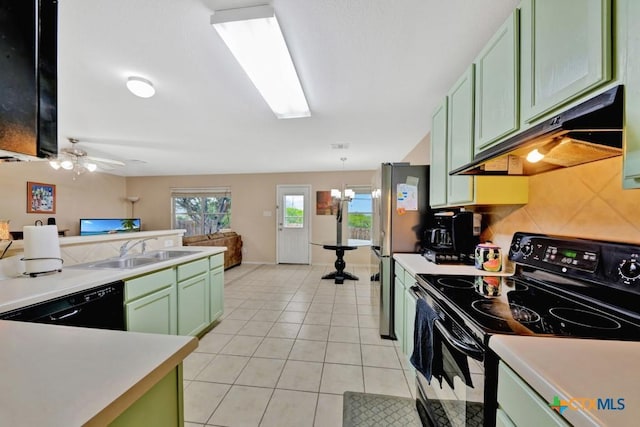 kitchen with under cabinet range hood, green cabinetry, a sink, and black appliances