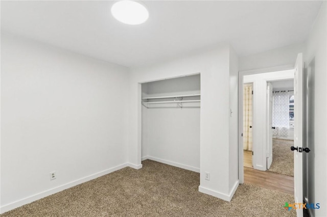 unfurnished bedroom with carpet flooring and a closet