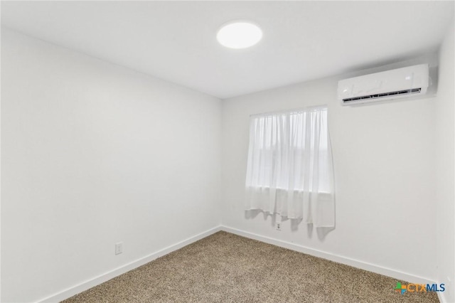 unfurnished room with a wall mounted AC and carpet