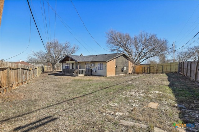 back of property featuring a deck and a lawn