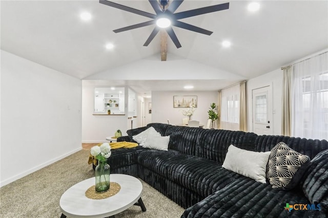 carpeted living room featuring ceiling fan, a healthy amount of sunlight, and vaulted ceiling with beams