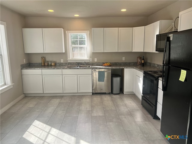 kitchen featuring sink, white cabinets, and black appliances