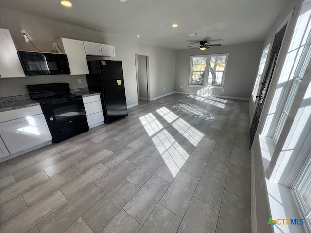 kitchen featuring light stone counters, ceiling fan, black appliances, white cabinets, and light hardwood / wood-style floors