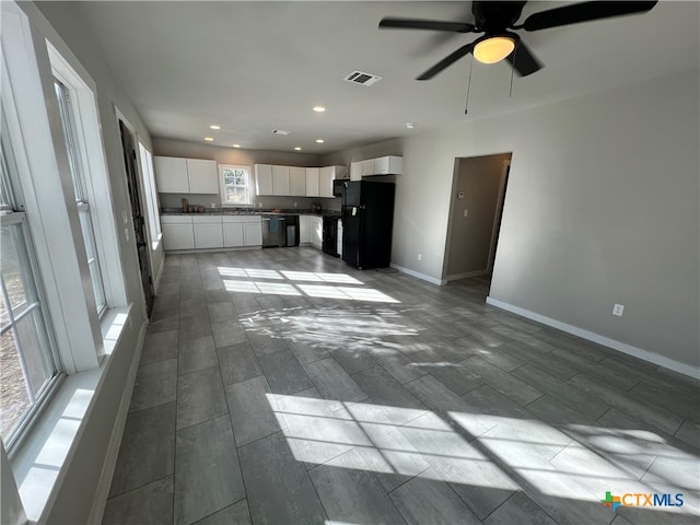 unfurnished living room with ceiling fan