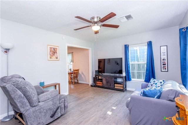 1310 S 49th St, Temple, TX 76504 - living room with wood finished floors, a ceiling fan, and baseboards