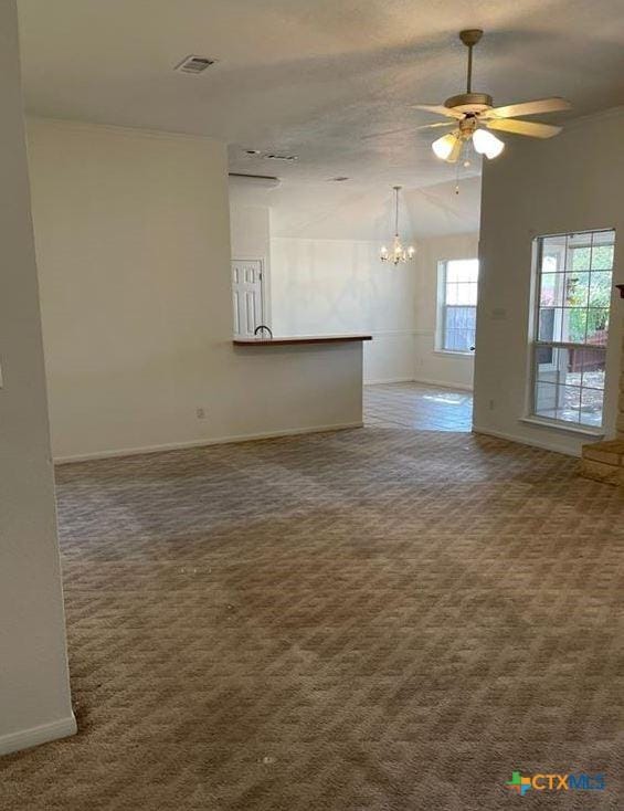 carpeted spare room featuring lofted ceiling and ceiling fan