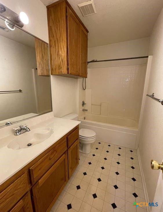 full bathroom featuring vanity,  shower combination, and toilet