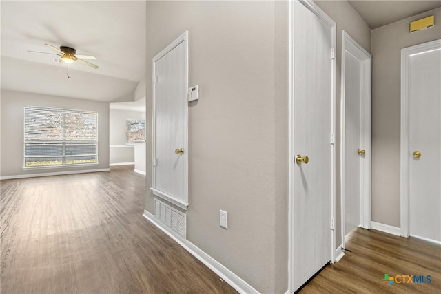 hallway with dark hardwood / wood-style flooring