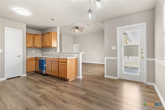 kitchen featuring ceiling fan, dishwasher, kitchen peninsula, decorative light fixtures, and hardwood / wood-style flooring