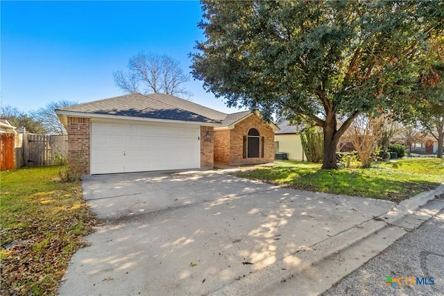 ranch-style house featuring a front yard and a garage