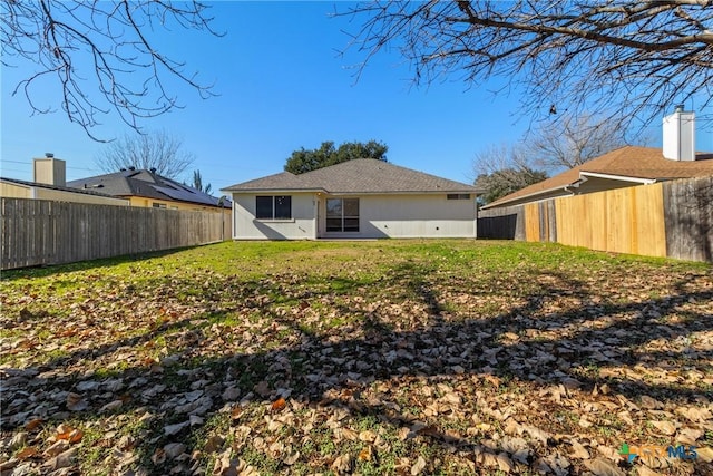 rear view of house with a lawn