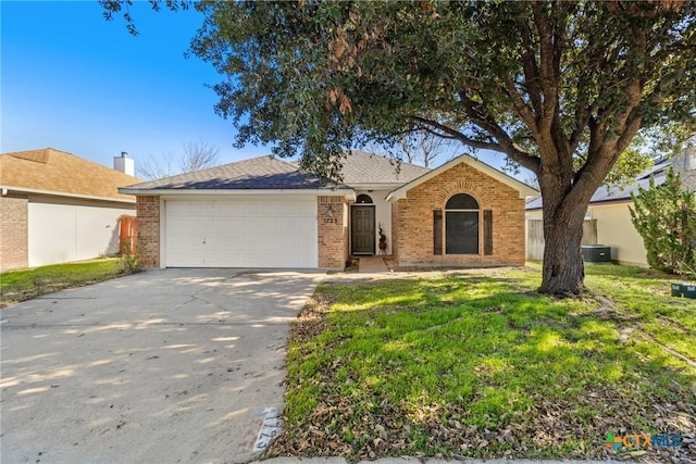 single story home featuring a front lawn, central AC unit, and a garage