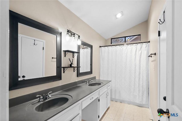 bathroom with lofted ceiling, a sink, curtained shower, and double vanity