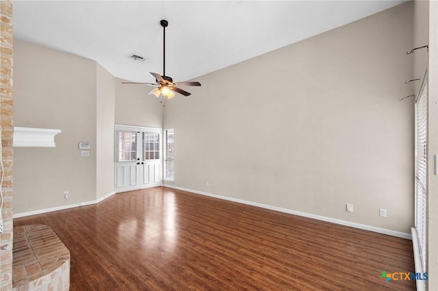 unfurnished living room with french doors, dark wood finished floors, visible vents, ceiling fan, and baseboards