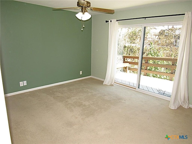 unfurnished room featuring a ceiling fan, carpet, and baseboards