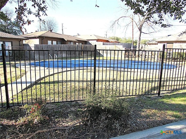 view of swimming pool with fence