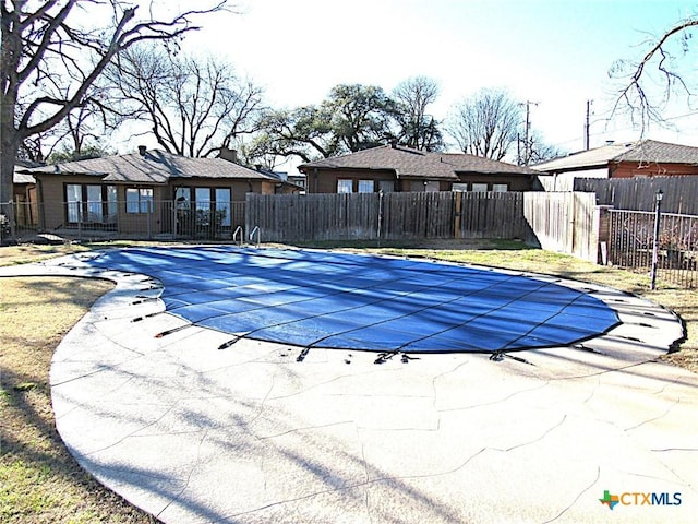 view of swimming pool with a patio area, fence, and a fenced in pool