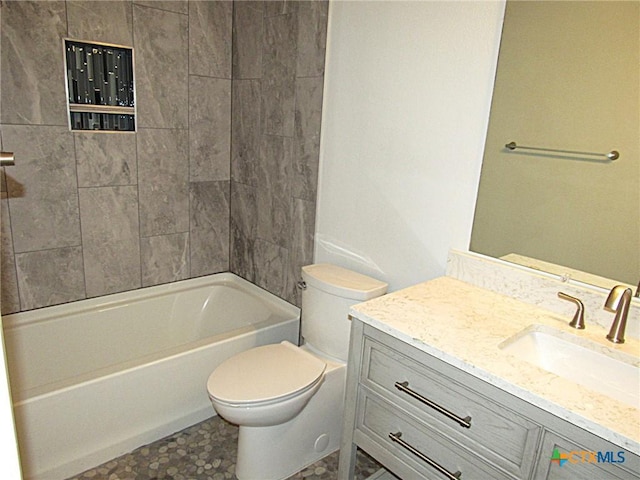 full bathroom featuring toilet, washtub / shower combination, and vanity