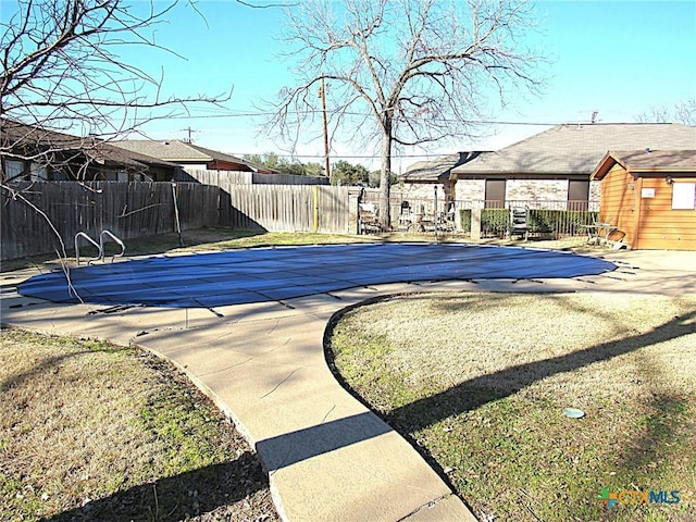 view of pool with a fenced in pool, a patio area, and fence