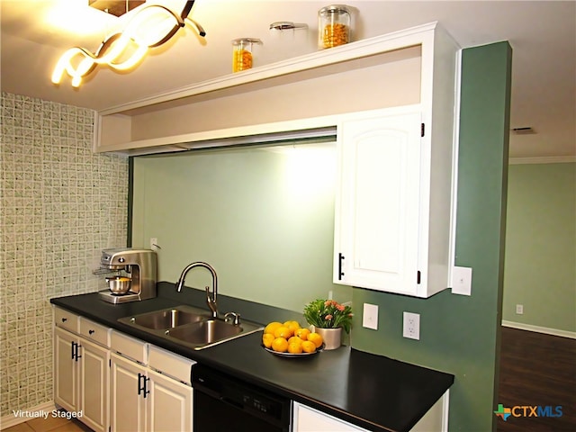 kitchen with dark wood-style flooring, a sink, white cabinets, dishwasher, and dark countertops