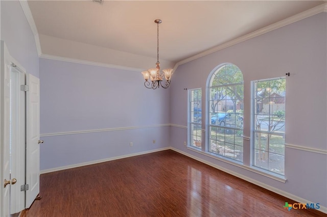 spare room featuring dark wood-style floors, plenty of natural light, and baseboards