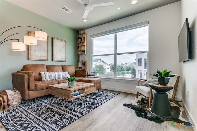 living room with ceiling fan and wood-type flooring