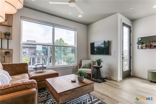 living room with light wood-type flooring and ceiling fan