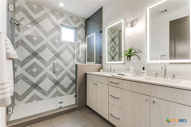 bathroom featuring vanity, tile walls, tile patterned floors, and a shower with door