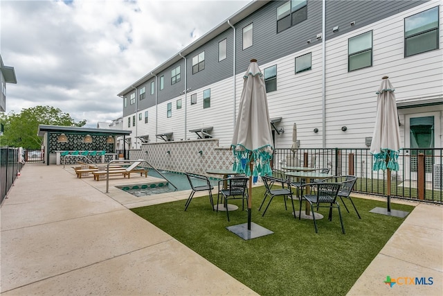 exterior space with a lawn, an outdoor fire pit, and a patio area