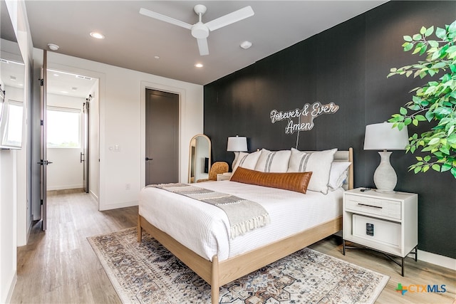 bedroom featuring light wood-type flooring and ceiling fan