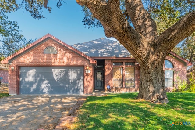 view of front of property with a garage and a front yard