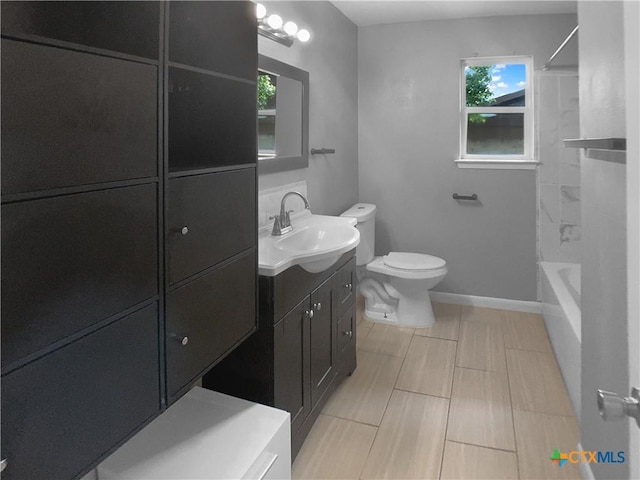 bathroom featuring vanity, baseboards, and toilet