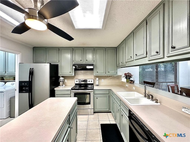 209 Westbrook Dr, Victoria, TX 77904 - kitchen with separate washer and dryer, appliances with stainless steel finishes, extractor fan, light countertops, and light tile patterned floors