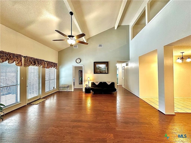 209 Westbrook Dr, Victoria, TX 77904 - living room featuring beam ceiling, wood finished floors, a ceiling fan, high vaulted ceiling, and a chandelier