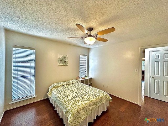 209 Westbrook Dr, Victoria, TX 77904 - bedroom featuring dark wood-style flooring, a textured ceiling, and a ceiling fan