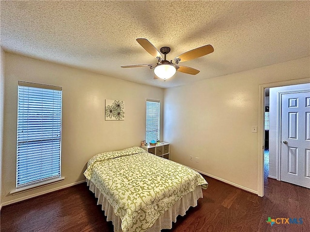209 Westbrook Dr, Victoria, TX 77904 - bedroom with dark wood-type flooring, a textured ceiling, and a ceiling fan