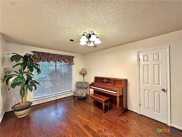 209 Westbrook Dr, Victoria, TX 77904 - living area with wood finished floors, a chandelier, and a textured ceiling