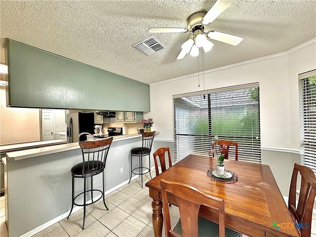 209 Westbrook Dr, Victoria, TX 77904 - dining space with a textured ceiling, ceiling fan, light tile patterned flooring, and ornamental molding
