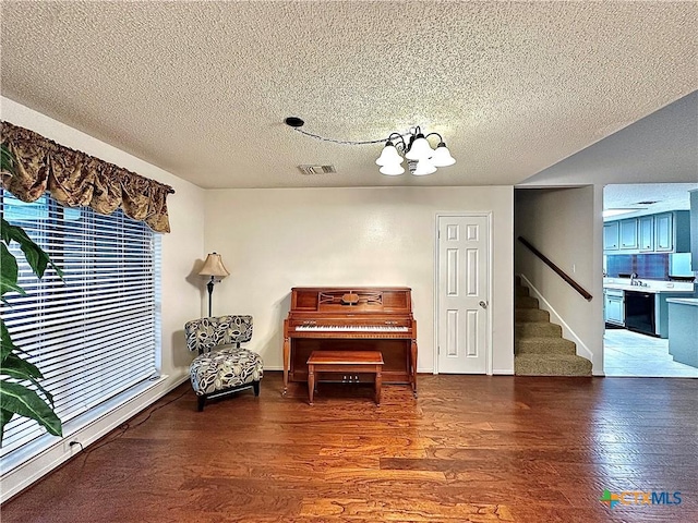 209 Westbrook Dr, Victoria, TX 77904 - living area featuring stairs, wood finished floors, a textured ceiling, and a chandelier