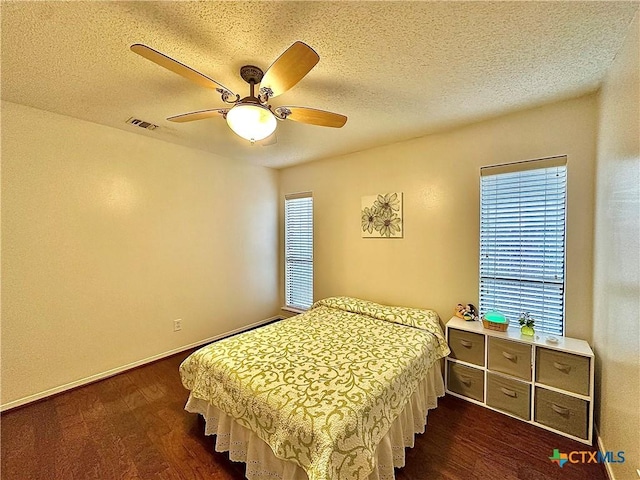209 Westbrook Dr, Victoria, TX 77904 - bedroom featuring dark wood-style flooring, a textured ceiling, and ceiling fan