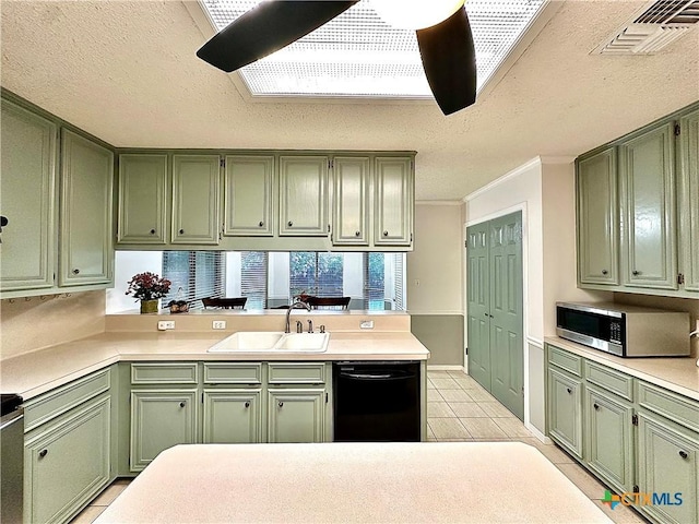 209 Westbrook Dr, Victoria, TX 77904 - kitchen with green cabinets, stainless steel microwave, black dishwasher, a peninsula, and light tile patterned floors