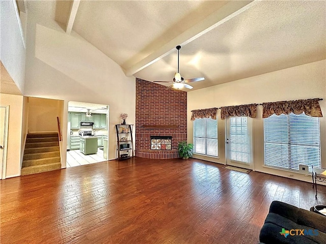 209 Westbrook Dr, Victoria, TX 77904 - unfurnished living room with ceiling fan, beam ceiling, wood-type flooring, high vaulted ceiling, and stairs