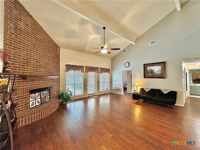 209 Westbrook Dr, Victoria, TX 77904 - living room with ceiling fan, high vaulted ceiling, wood finished floors, a fireplace, and beam ceiling